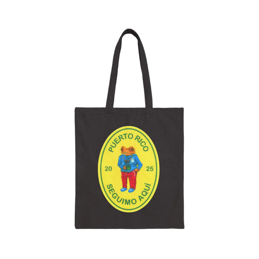 Black tote bag with a colorful graphic of a frog and text on a black background